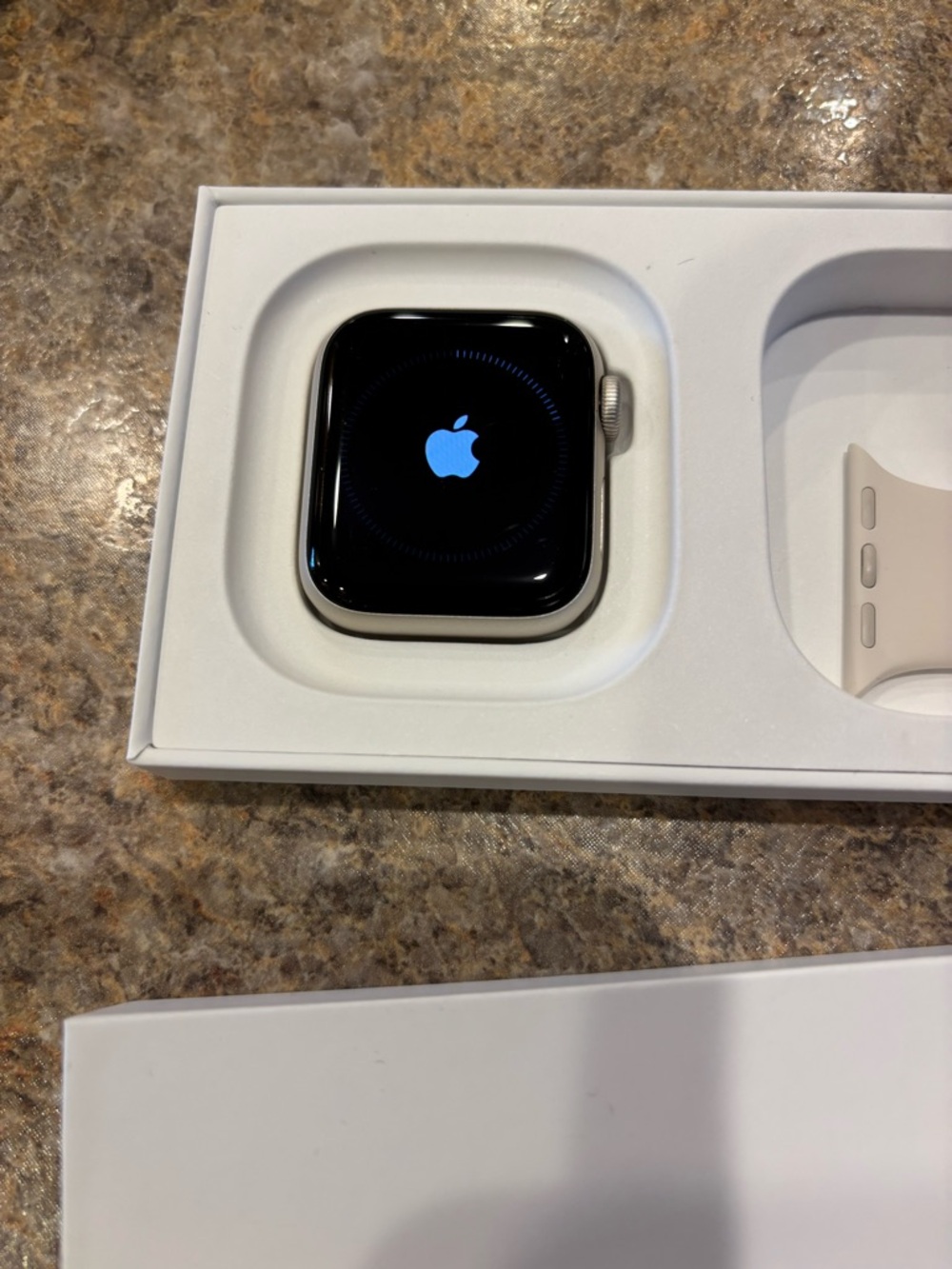 Apple Watch SE 3, like new. Has a white band and also a blue solace band